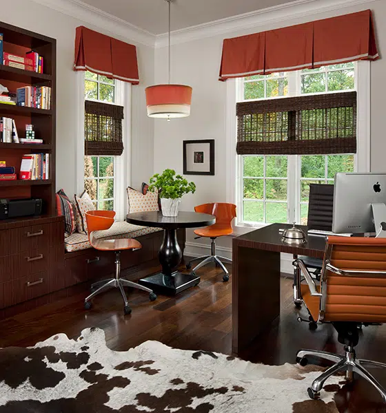 an office filled with furniture and a fireplace