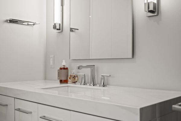 a kitchen with a sink and a mirror