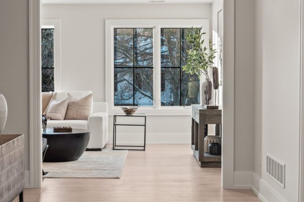 a view of a living room filled with furniture and a large window